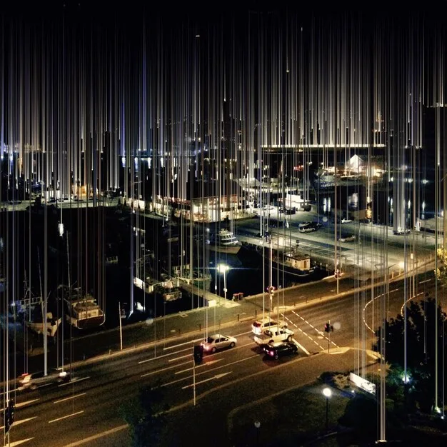 A futuristic cityscape at night with visible 5G wireless signals connecting buildings and vehicles, highlighting the role of wireless backhaul in enabling smart city infrastructure.