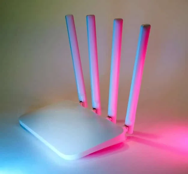 A close-up shot of a modern Wi-Fi 6 router with multiple antennas, showcasing its sleek design and advanced features for improved wireless performance.
