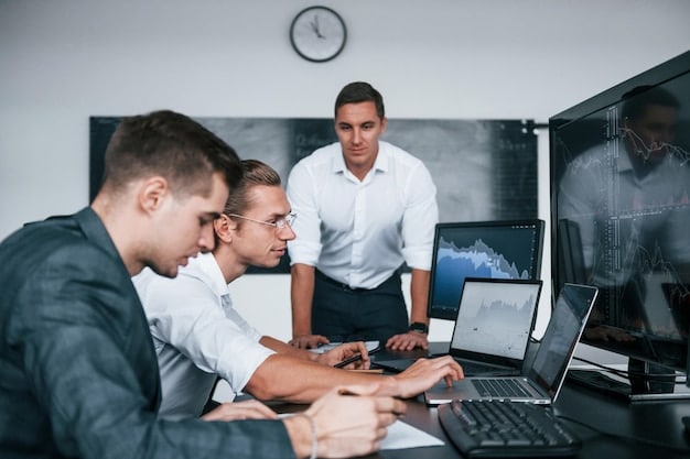 A group of cybersecurity professionals participating in a hands-on training session, using laptops and network equipment to simulate real-world scenarios. The image should convey a sense of active learning and skill development.