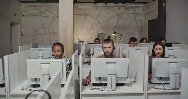 A diverse group of employees actively participating in an interactive cybersecurity training workshop, using laptops and engaging with the trainer. The setting is a brightly lit, modern office space.