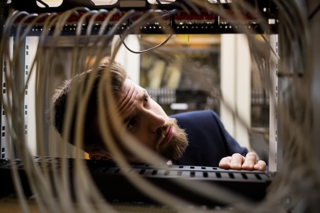A network engineer working on a complex fiber optic cable installation in a data center, showcasing the intricacy and expertise required for fiber deployment.