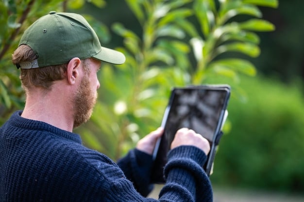 A close-up shot of a farmer using a tablet to monitor and control irrigation systems in a field. The tablet displays real-time data from soil moisture sensors, showing the farmer making adjustments based on the information received.